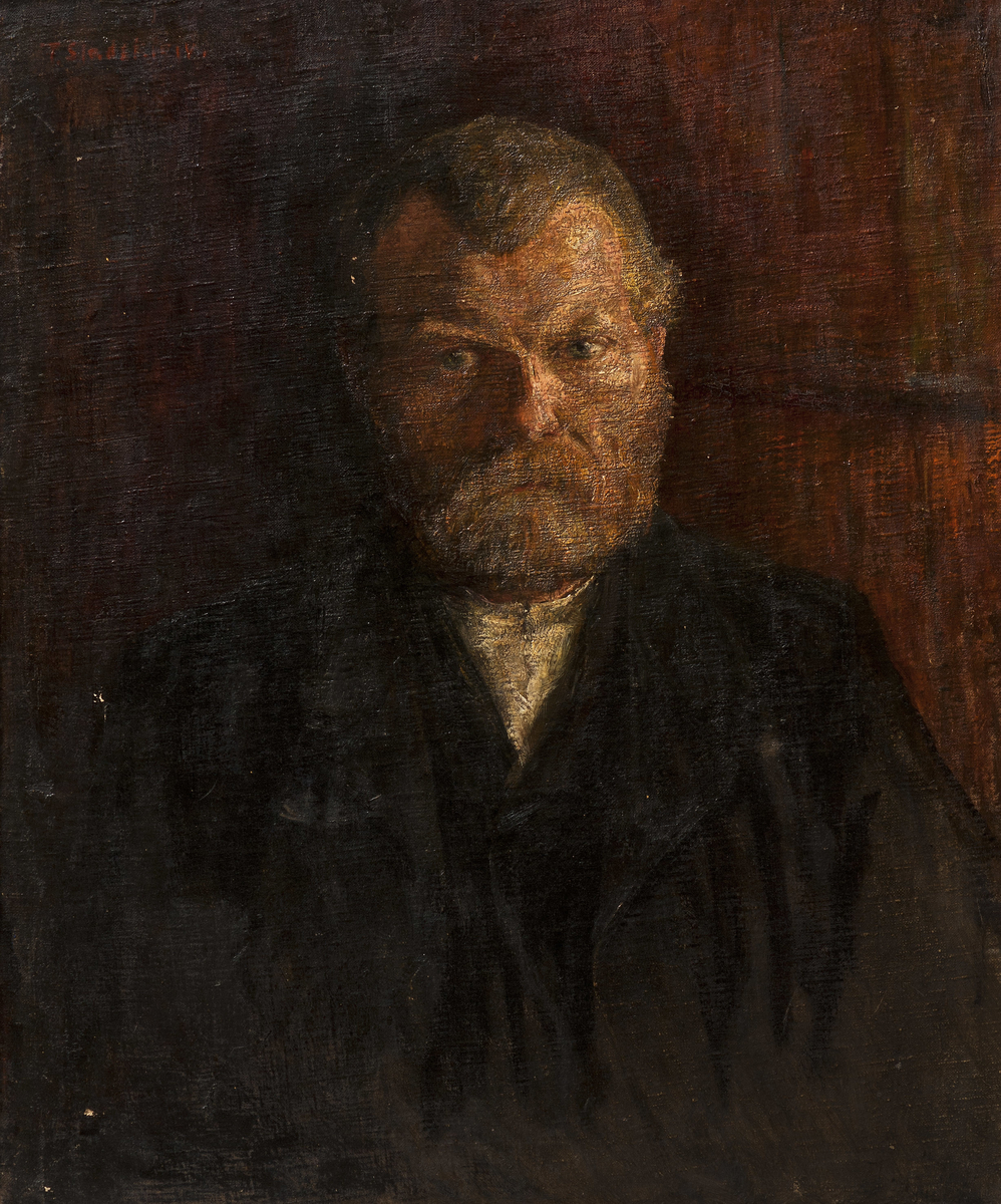 Portrett av mann med skjegg i halvfigur. 