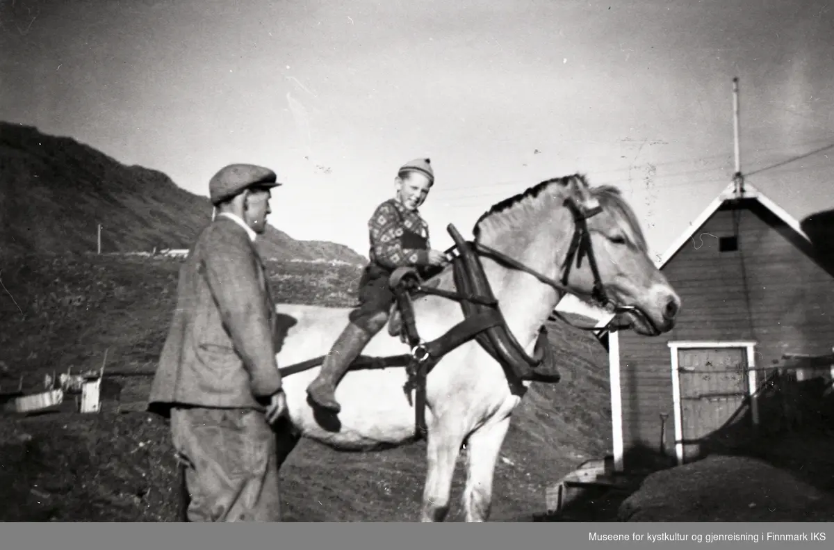 Honningsvåg. Cato og John Grøtta i Elvedalen. John sitter på en av familiens to hester, fjordingen Petter. 1950-tallet.