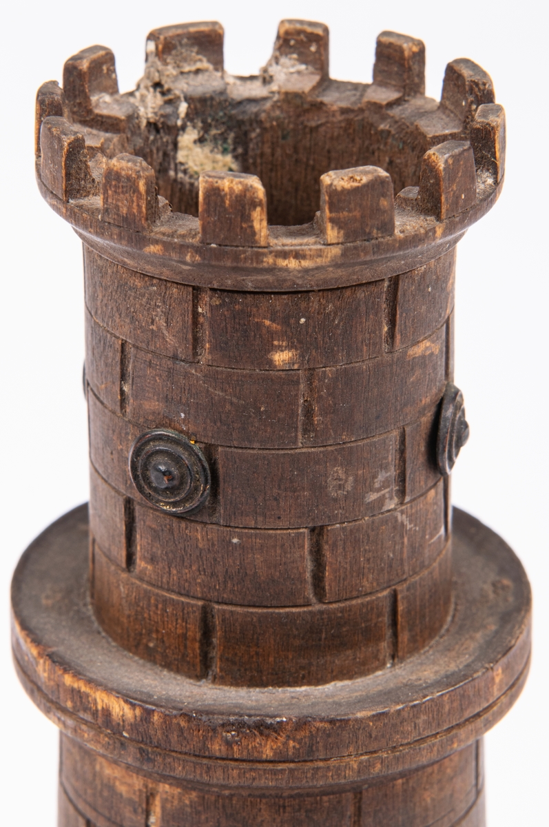 Cigarr- och tändsticksställ, av trä, i form av ett torn med tinnar, en fyrsidig platta som fot.