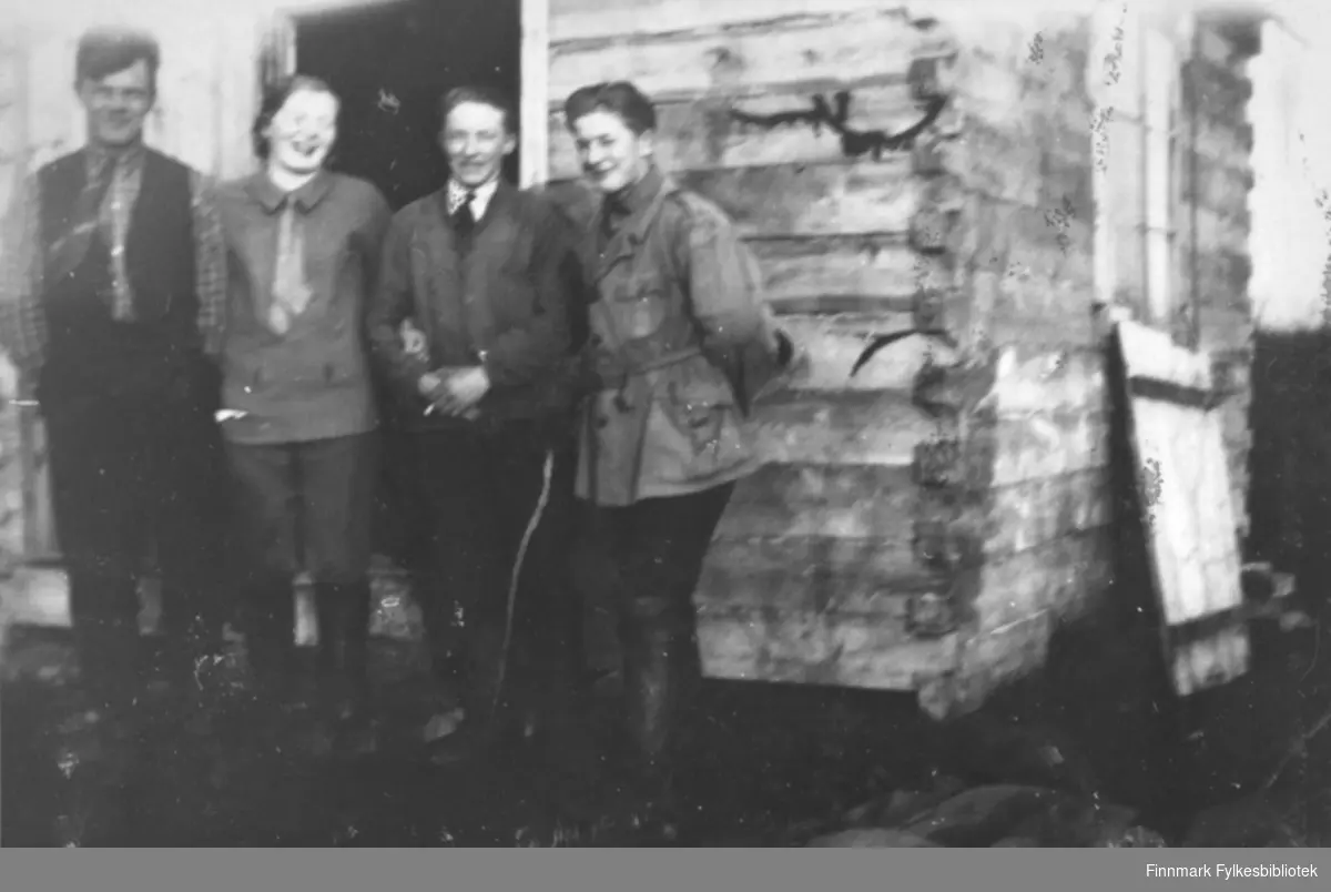 Tre menn og en dame foran et hus i Salttjern.