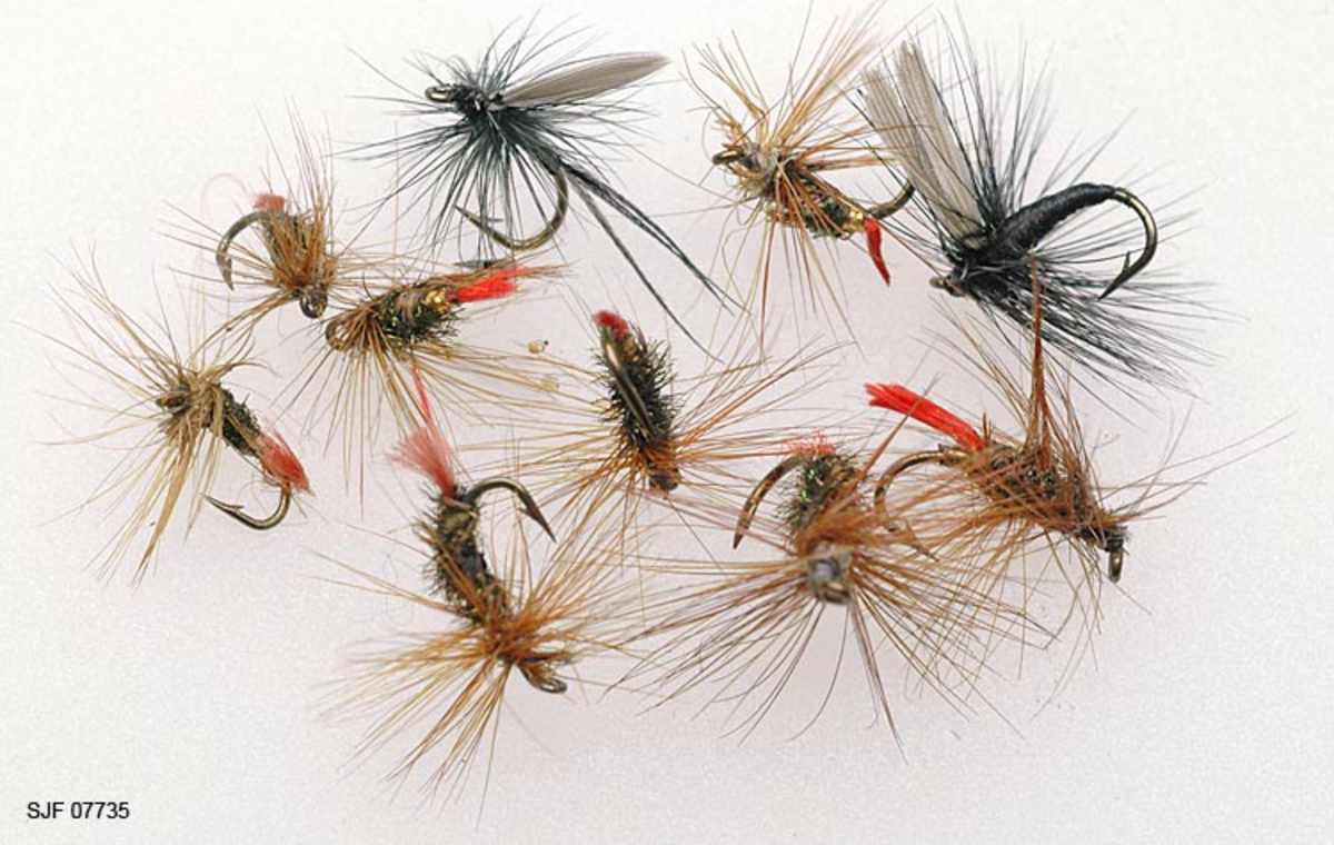 Tilstand: I forbindelse med omfotografering av gjenstander høsten 2002 fant OT Ljøstad at alle fluene i ett av eskens rom var helt ødelagte av møll, mens fluene i et annet rom var delvis ødelagte.  Skadene skyldes lagring i magasin C, som har temperaturforhold som møllen tåler. 

Boksen inneholder ialt 104 fluer. For å nevne noen: Red Tag og Black Gnat. Tørrfluen flyter og kan sees selv i dårlig belysning da den flyter høyt på grunn av de lange armene. Boksen har ialt 10 rom. Giveren har skrevet ei bok med navnet "Isfiske" sammen med Knut Rom. Giverens far var en ivrig sportsfisker og er gitt tittelen "Den fullendte sportsfisker". 