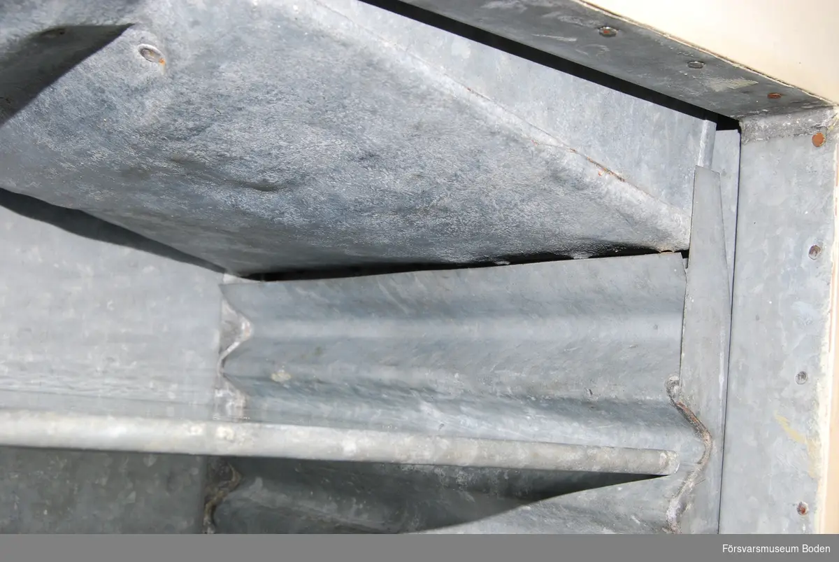 Isskåp av trä med bleckplåtsklädd isbehållare upptill. Smältvattnet rinner längs skåpets sidor ner till behållare i botten med kran för avtappning. Skåpets inredning består av tre glashyllor med lister av metall i framkanten. Insidan är klädd med bleckplåt, där sidorna har vågig form för att möjligge valfri placering av hyllorna. Skåpets dörr är låsbar.