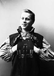 Studioportrett av ung mann i drakt.