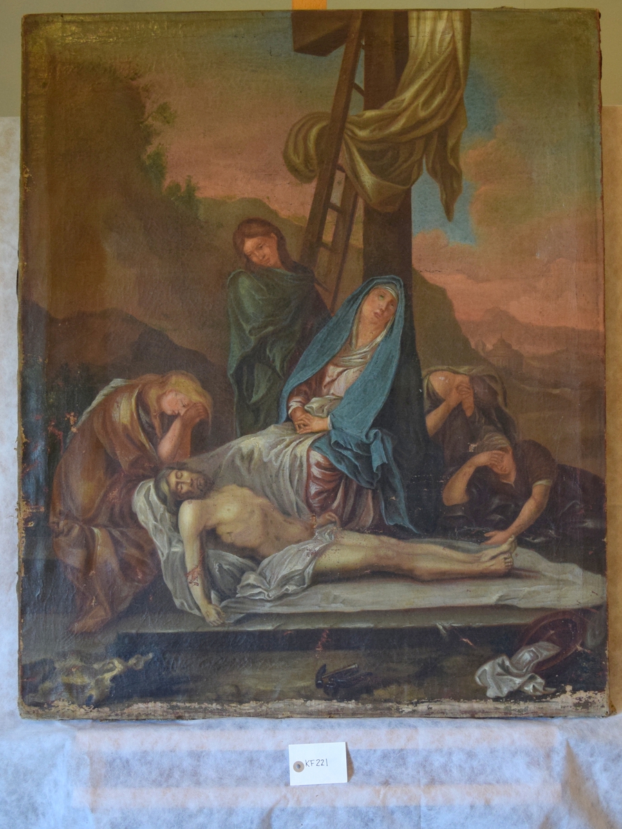 Jesus Kristus tatt ned av korset. Bak ham Maria i blå kappe, omkring dem er fire figurer, en av dem er kledd i grønt.