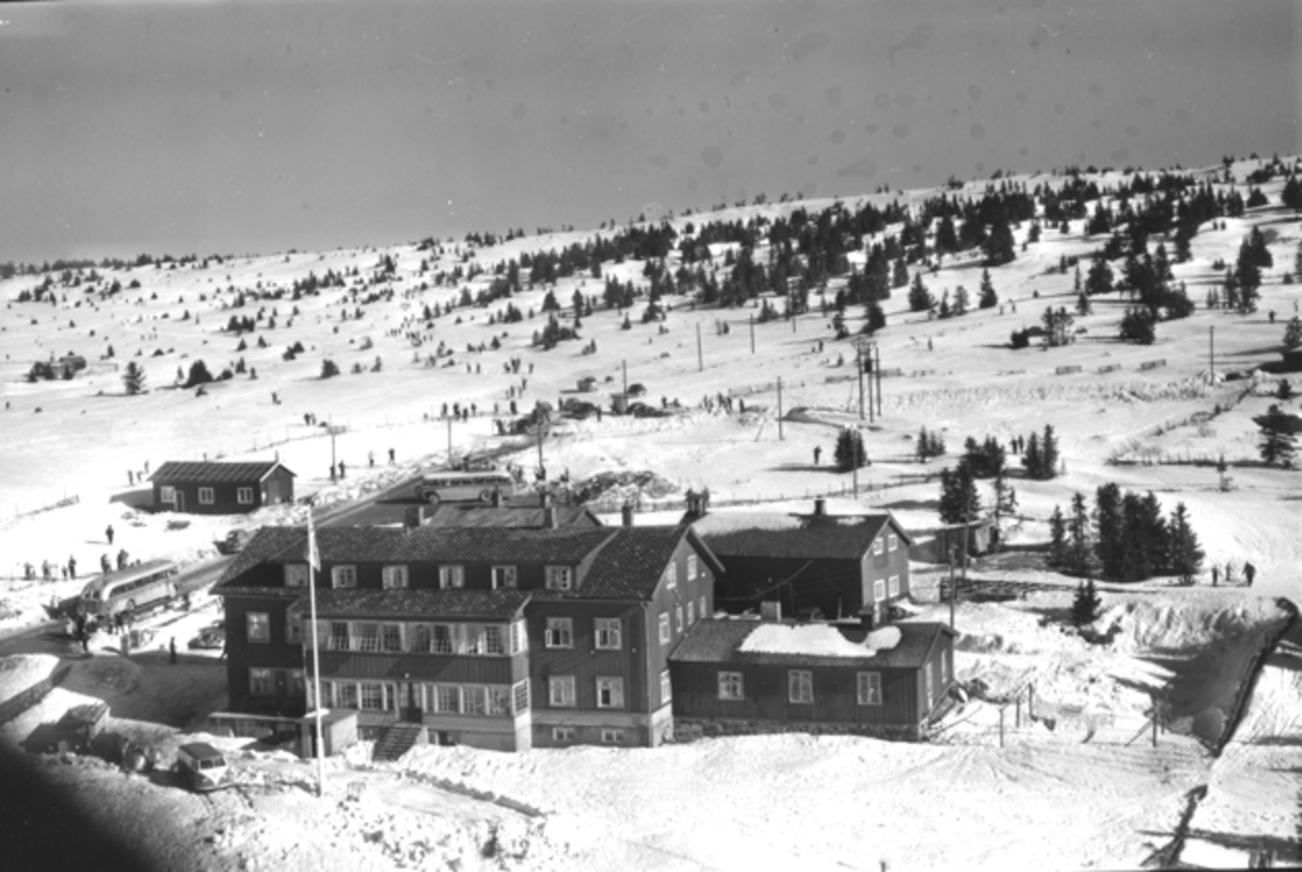 Flyfoto av bebyggelse i vinterlandskap på Sjusjøen, Ringsaker Almenning.