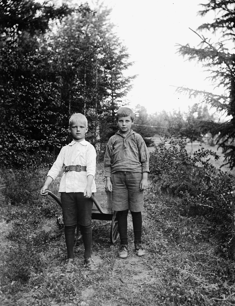 To gutter med kjerre. Wilhelm O. Dybwad og Håkon B. Halvorsen, sønn av statsminister Otto B Halvorsen. I Kvalstua, Helgøya.