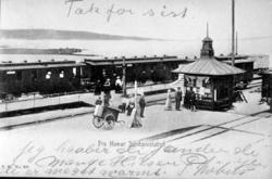 Hamar stasjon med noen av vognene i et tog på normalspor, re