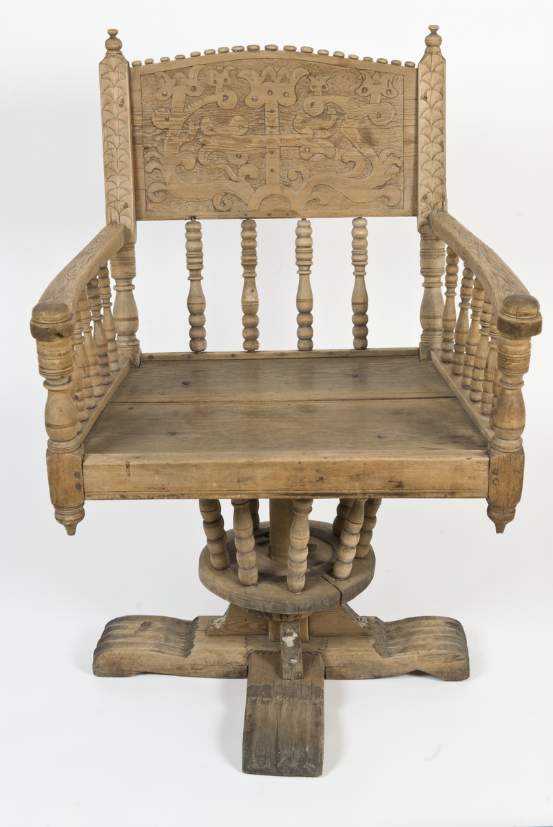 Armstol på kryss fot med mulighet for å snurres. Runeinnskrift skåret inn på ryggen. Dreid og skåret dekor.